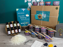 Load image into Gallery viewer, Purple Turtle Co. Candle Making Activity Kit with materials on a wooden surface against a teal wall.