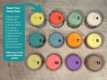 Load image into Gallery viewer, Color dye options for candles on a wooden surface with labels.
