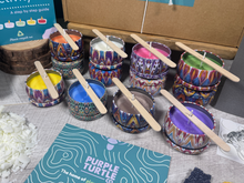 Load image into Gallery viewer, Colorful candles with wooden sticks on a table with a branded card.
